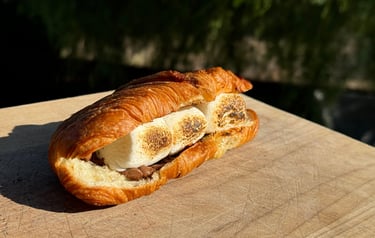 S’morissant dessert with melted chocolate and marshmallows inside a freshly grilled croissant