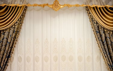 Elegant luxury gold and blue damask curtains with white lace sheers and ornate window valance decor.