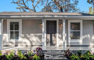 Exterior of a single-story home with a covered front porch and columns.