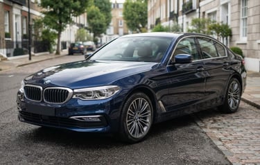 Three-quarter view of a clean, professionally detailed dark blue sedan parked on a quiet street in soft overcast daylight, sharp focus, professional editorial style, 50mm lens