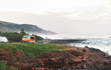 unrise over a campervan parked on a scenic cliffside, ready for a day of exploration