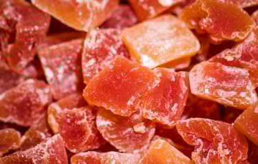 Close-up of red and orange semi-processed salt bricks and tiles, chipped from larger blocks.