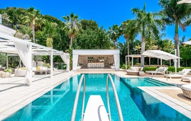 Villa Serenity pool with pergola, bar, and sun loungers under tropical palms