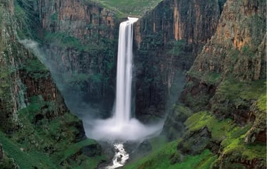 Maletsunyane Falls cascading down a steep rocky gorge into a misty pool in Lesotho.