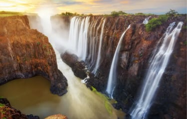Sunset over Victoria Falls waterfall on the Zambezi River between Zambia and Zimbabwe.