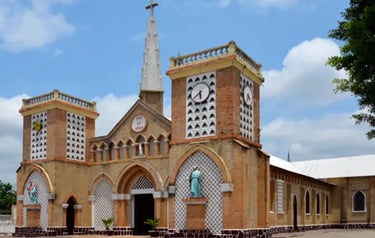 Historic brick architecture of the Sacre Couer cathedral in Brazzaville under a blue sky.