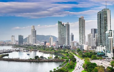 Panoramic skyline of Panama City featuring modern skyscrapers, the coastal beltway, and scenic bay views.