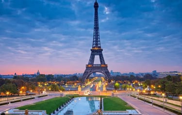 The Eiffel Tower at sunrise overlooking the Trocadéro gardens and fountains in Paris, France.