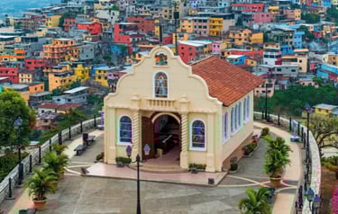 A cream-colored hilltop chapel overlooking the colorful houses of Guayaquil, Ecuador, at Santa Ana Hill.