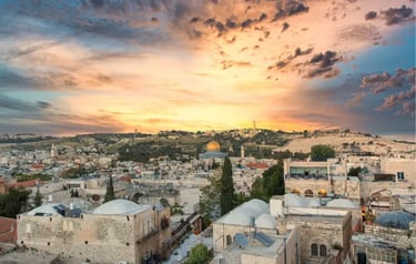 Jerusalem Old City skyline with Dome of the Rock under a vibrant sunset sky.
