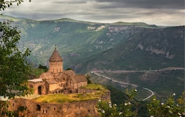 The historic Tatev Monastery perched on a basalt plateau overlooking the Vorotan River canyon in Armenia.
