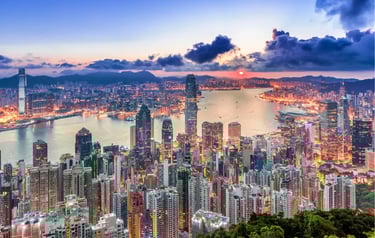 Panoramic sunset view of Hong Kong skyline and Victoria Harbour from Victoria Peak.