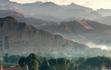 Misty morning view of the Bamiyan Valley mountains and ancient Buddha cliff niches in Afghanistan.