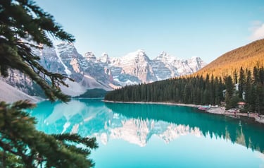 Scenic landscape of Moraine Lake in Banff National Park with turquoise water reflecting snow-capped Rocky Mountains.