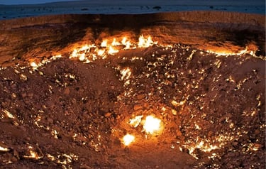 The Darvaza Gas Crater, also known as the Door to Hell, burning at night in the Turkmenistan desert.