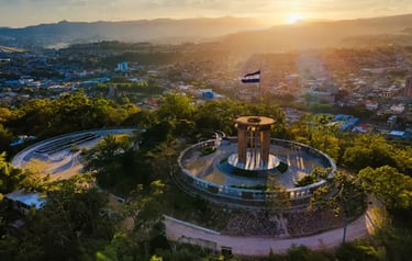 Aerial view of Cristo del Picacho park in Tegucigalpa, Honduras, at sunset with the national flag.