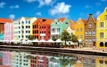 Colorful colonial architecture in Willemstad, Curacao, reflecting in the water of St. Anna Bay.
