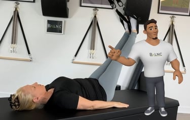 Image of Coach Tony with a woman working with a suspension trainer