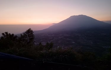 a mountain view of a mountain range at sunset
