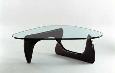 Isamu Noguchi glass coffee table with curved wooden base, reflecting light furniture and sculptural