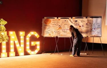 a woman drawing on a white board