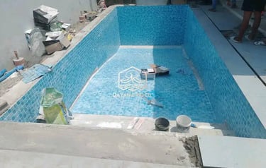 Kolam renang berbentuk lingkaran dan keramik berwarna biru.