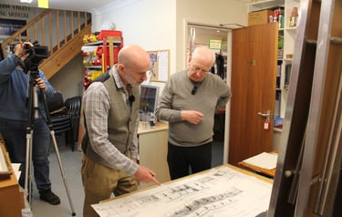 Andrew and Stephen look at station plans together