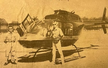 a man standing next to a helicopter