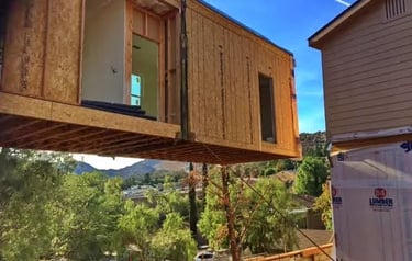 Modular home lifted with a crane to set on founation.