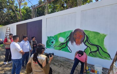 Ministery of Culture gathering during a colorful street art mural of a jaguar and figure is painted.