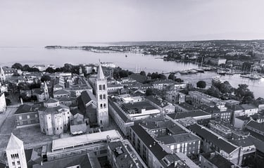 A bird view photo of Zadar peninsula, with the Church of St. Donatus, The Cathedral and Bell Tower