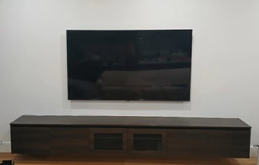 Space-saving ultra slim TV wall mounting for a compact apartment living room in Melbourne CBD.