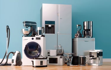 A variety of modern household appliances, including a refrigerator, washing machine, vacuum cleaner, and kitchen mixers,