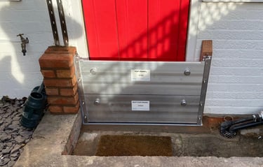 a red door fitted with flood defence barrier