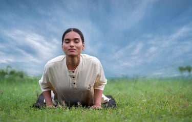 a woman doing Yoga on a grassy field