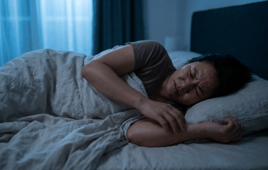 Pessoa tentando dormir desconfortável com o calor