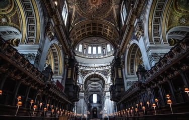 Interior view of St. Paul's Cathedral in London featuring ornate architecture, a high dome, and choir stalls.