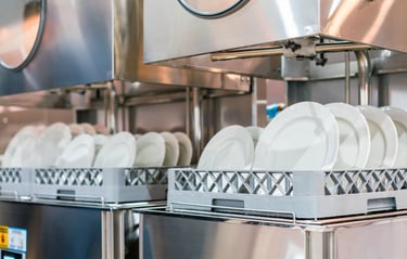 Commercial dishwasher loaded with plates, showcasing efficient cleaning equipment for restaurants and businesses
