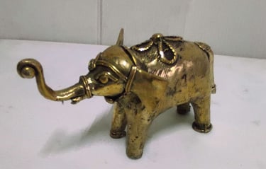 "Handcrafted shiny brass baby elephant with tribal engravings, left side view-Going abroad"
