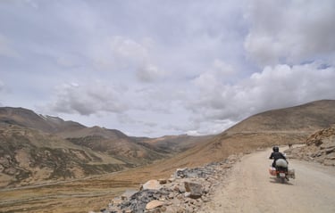 Tracey Billington riding the Leh to Manali highway over the great Himalayan range, Ladakh, India 