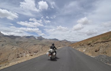 Tracey Billington riding the Leh to Manali highway over the great Himalayan range, Ladakh, India 