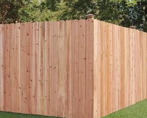 a fenced in backyard with a wooden fence