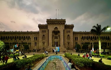 a large building with a fountain in front of it
