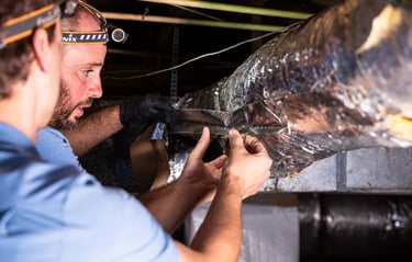 Clint Smith and Jayden Kelley repair ductwork