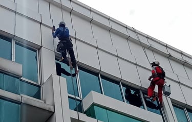 two men are cleaning windows in a building