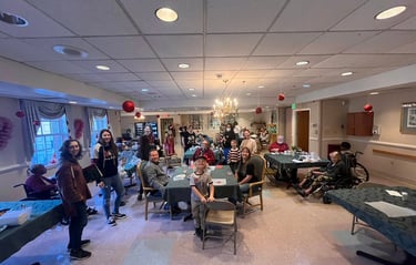 group of volunteers with Untether Life interacting with seniors