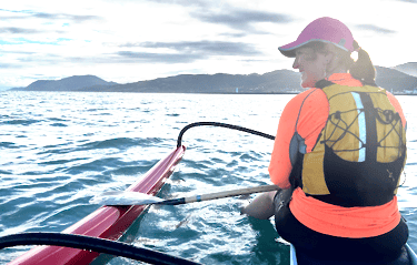 Woman in a life vest on an outrigger