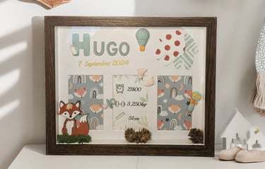 a picture of a framed picture of a baby's birth announcement