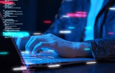 A programmer writing code on a laptop