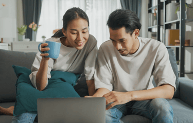 A couple looking at health resources on the computer.